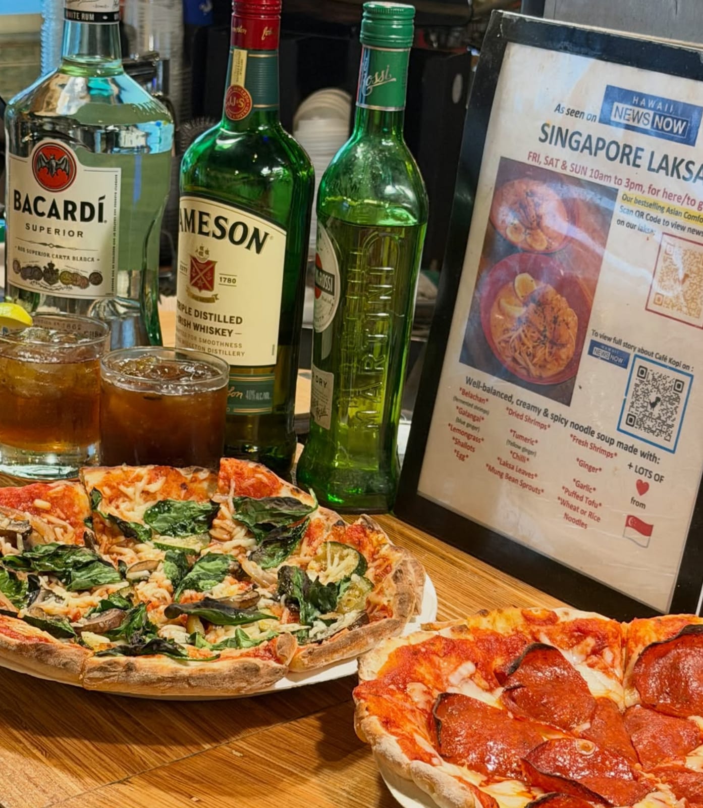 Pizza and drinks — the kitchen runs all night alongside the bar.